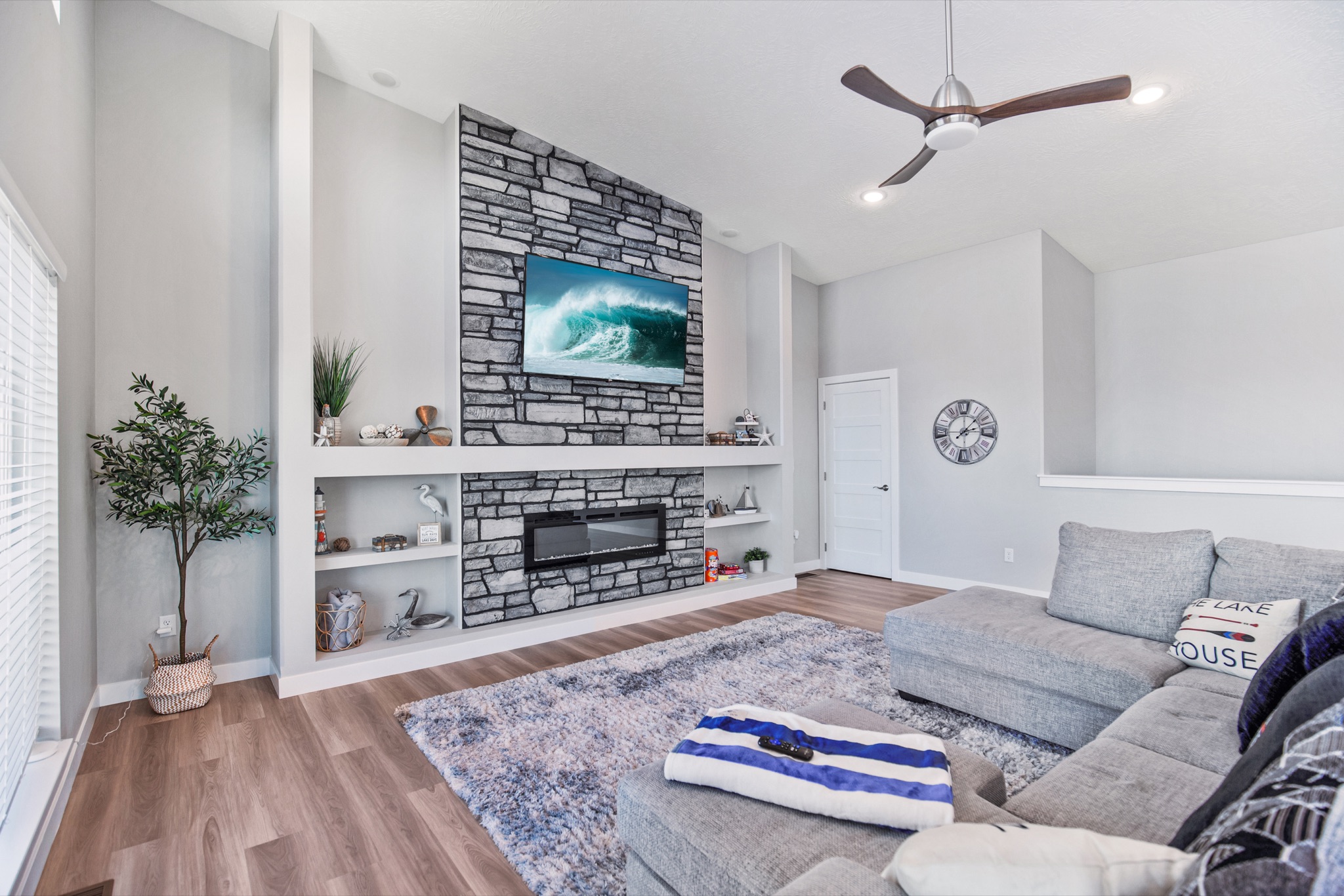 Upstairs great room with stone fireplace and sectional
